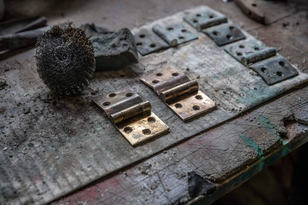 A picture of some hinges during the restoration of the glasshouses