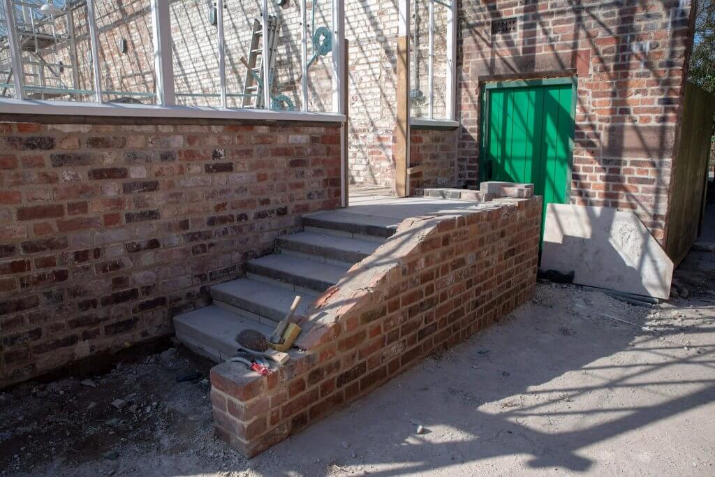 Steps up to the glasshouses, part of the restoration gallery depicting the restoration of the glasshouses