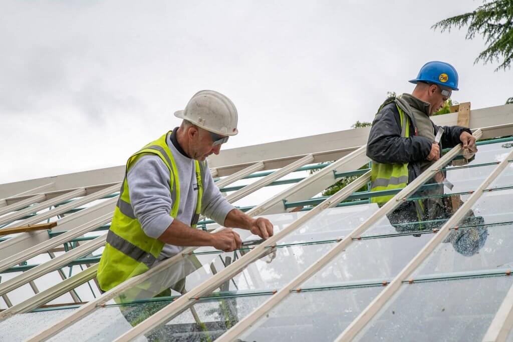 Man fixing up the glass on top of the glasshouses. Picture taken for the glasshouses restoration gallery