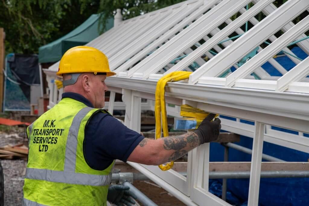 Bringing the timber frames together with a clamp. Part of the glasshouses restoration gallery.