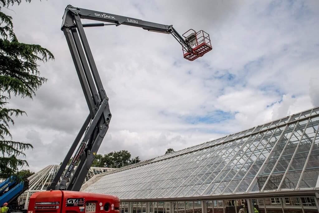 Man on a cherry picker. Picture captured by Andy Gilbert for the glasshouses restoration gallery