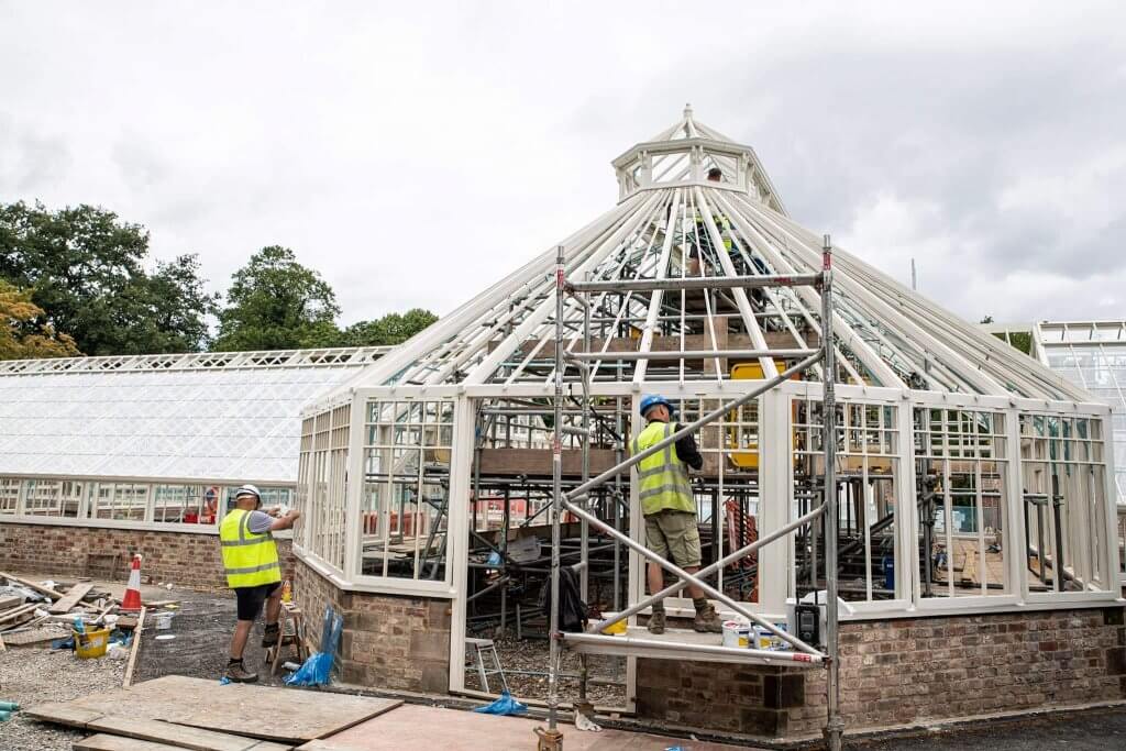 Man working on scaffold up against the conservatory. Glasshouses restoration gallery pic taken by Andy Gilbert.