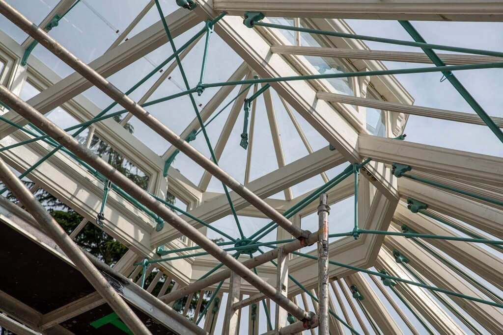 Picture taken inside the glasshouses as they await the glass panels. Picture shows the ironwork. Part of the glasshouses restoration gallery.