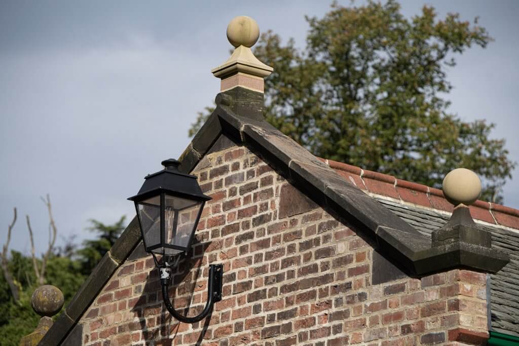 Old carriage lamp mounted on the side of the shippon buildings