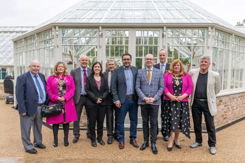 A group photo taken outside the glasshouses.