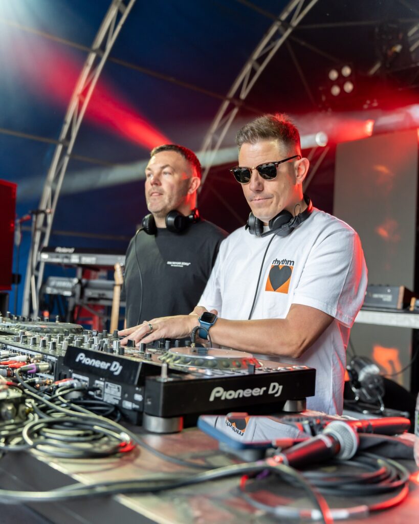 DJ's on the stage perform their set for the crowd.