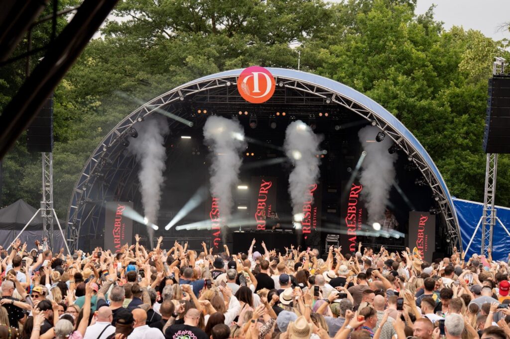 smoke machines fill the Daresbury Festival stage as a huge crowd looks on.