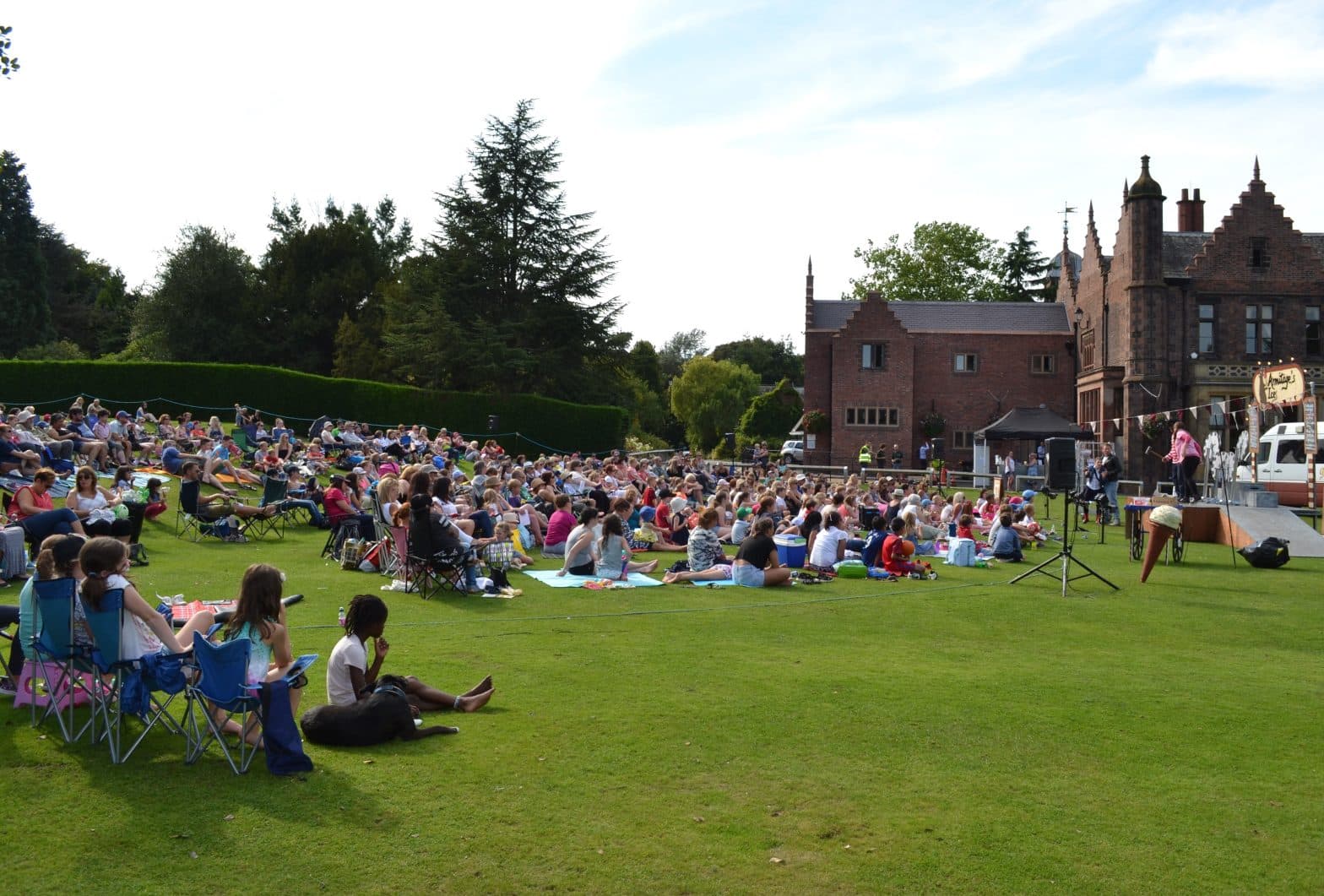 crowd of people enjoying outdoor theatre at Walton Hall and Gardens