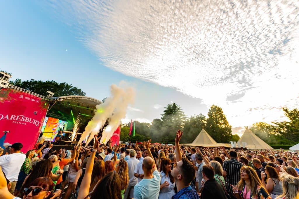 Crowd and stage shot with bright blue skies and clouds