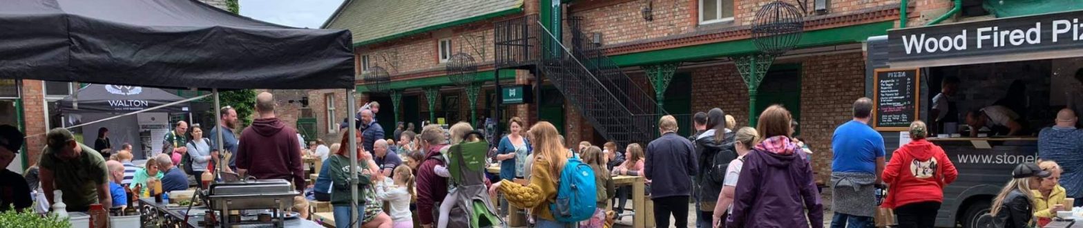 Stables courtyard with stalls and people